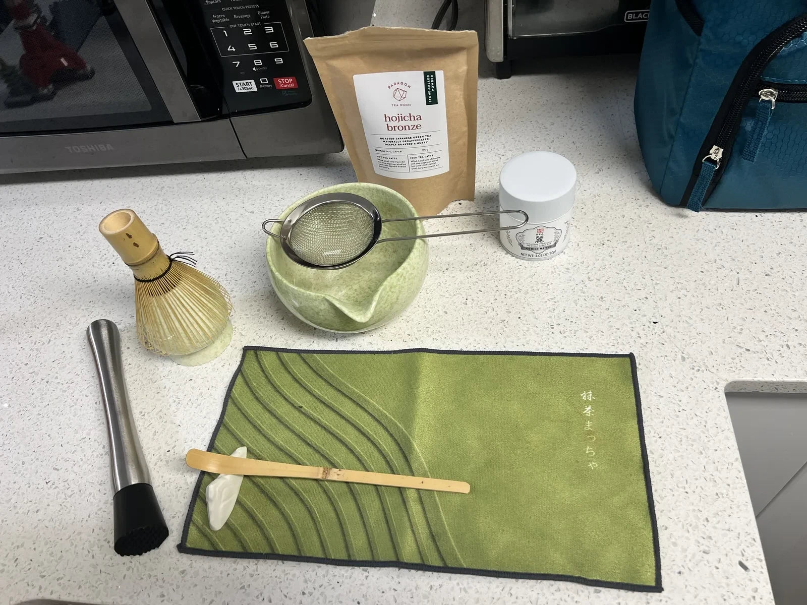 Traditional matcha ceremony tools: chasen, chawan, chashaku, and matcha cloth